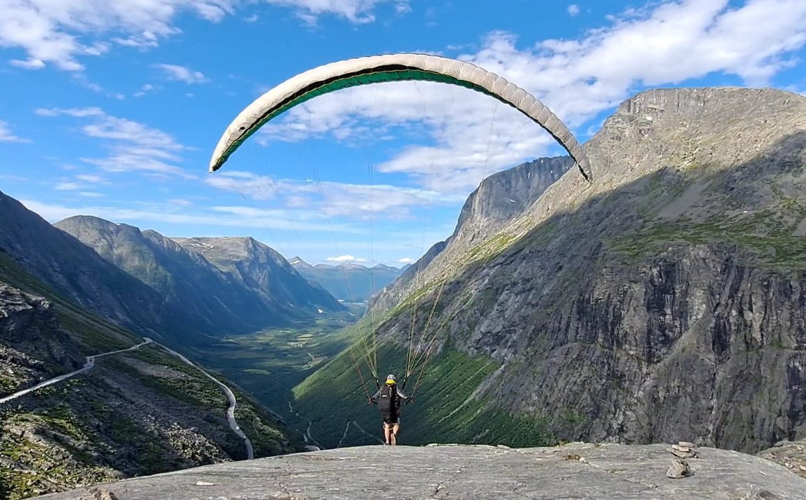 person paragliding near mountain at daytime
