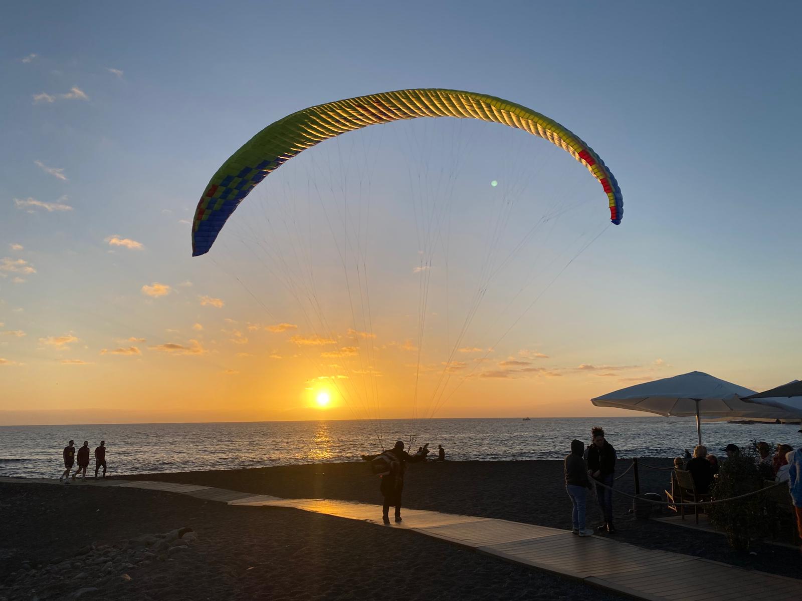 person paragliding near mountain at daytime